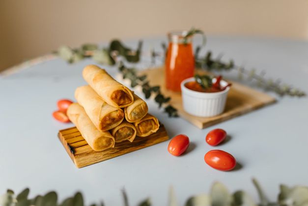 spring rolls stacked in a triangle with sweet chilli dip